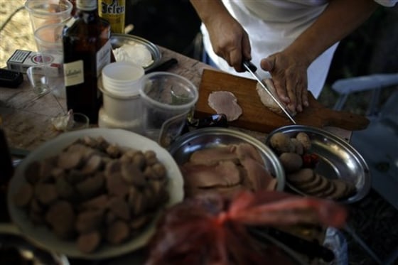 A participant of the so-called 7th annual World Testicle Cooking Championship prepares a dish in the village of Ozrem, some 90 miles south of Belgrade, Serbia. At the seventh annual World Testicle Cooking Championship, visitors watch - and sometimes taste, as teams of chefs cook up bull, boar, camel, ostrich and even kangaroo testicles.
